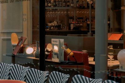 Café élégant à Paris présentant des chaises et des tables sophistiquées prêtes pour les clients.
