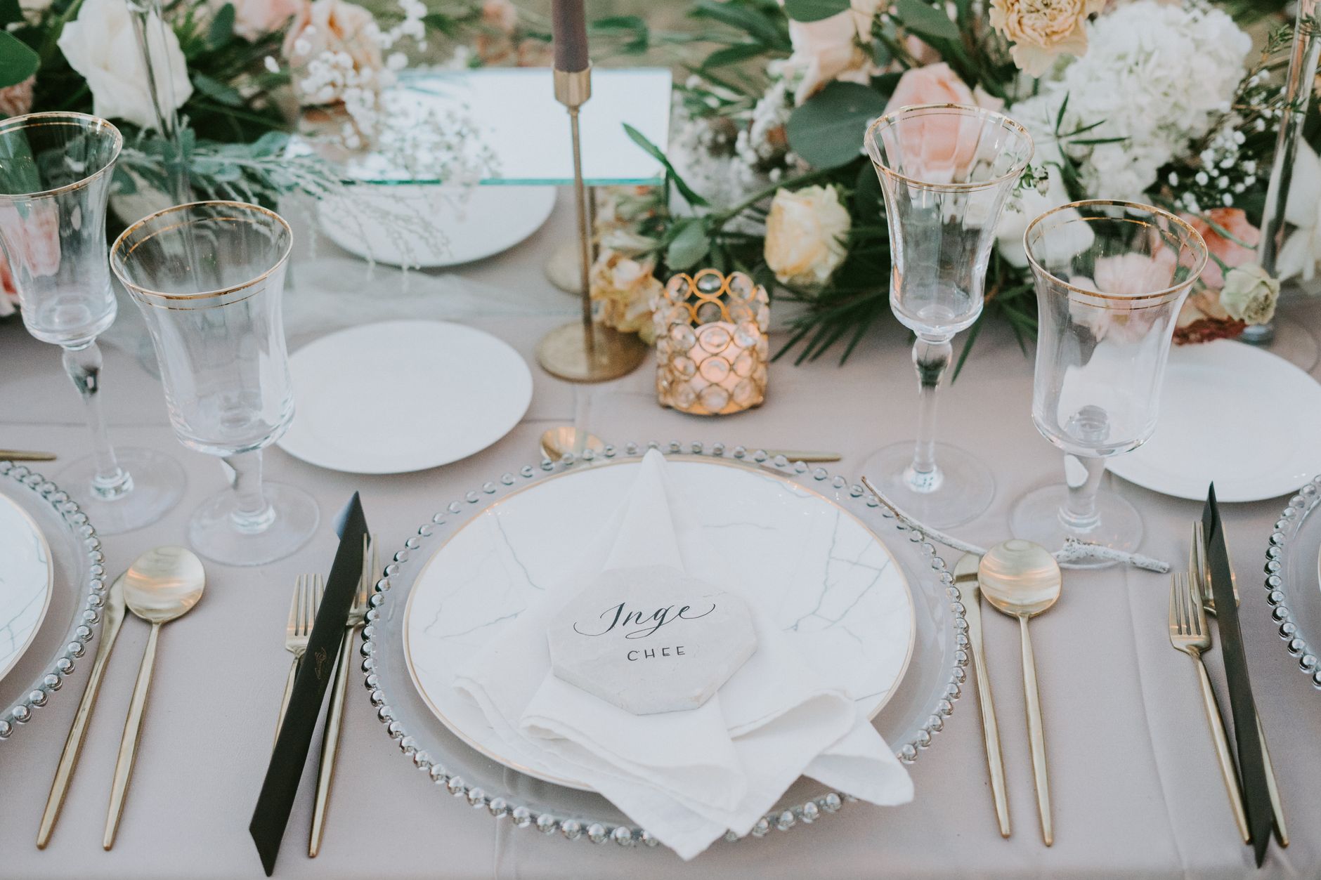 Table de réception avec couverts, assiettes et fleurs